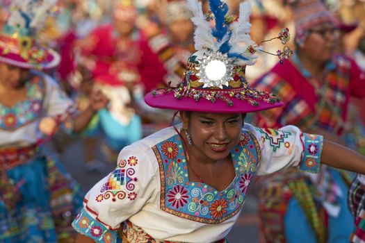 Tinku dancing group in colourful costumes performing a traditional ritual dance as part of the Carnaval Andino con la Fuerza del Sol in Arica, Chile.