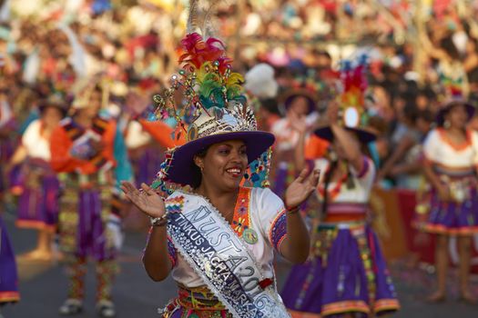 Tinku dancing group in colourful costumes performing a traditional ritual dance as part of the Carnaval Andino con la Fuerza del Sol in Arica, Chile.