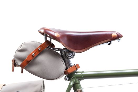 Vintage road bicycle saddle with under saddle bag, isolated on white.