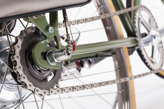 Composition with back bicycle crank and chain on white background.