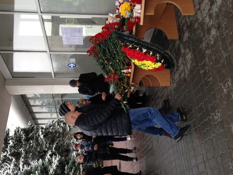 RUSSIA, Rostov-on-Don : Men lay flowers at the airport entrance in Rostov-on-Don on March 19, 2016.A flydubai passenger jet crashed in southern Russia early Saturday, killing all 62 people on board as it tried to land in bad weather in the city of Rostov-on-Don, officials said. The Boeing 737, heading from Dubai to the southern Russian city, was reportedly making its second attempt to land at 0050 GMT when it missed the runway, erupting in a huge fireball as it crashed, leaving debris scattered across a wide area.