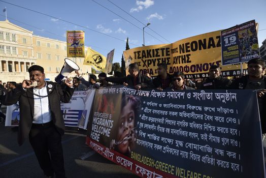 GREECE, Athens: Migrants march in front of the Greek Parliament holding banners and shouting slogans March 19, 2016 in Athens.Hundreds of migrants and supporters took part in a protest march in central Athens, condemning border fences and the NATO involvement in the refugee crisis. The protesters are calling for open borders to help the influx of migrants who are struggling in camps.