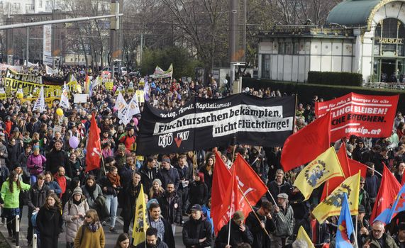 AUSTRIA, Vienna: Thousands march holding banners and waving flags on March 19, 2016 in Austria.The demonstrators have denounced 'fortress Europe' and demanded an end to racism. The demonstrators marched through Vienna, holding signs and waving flags.