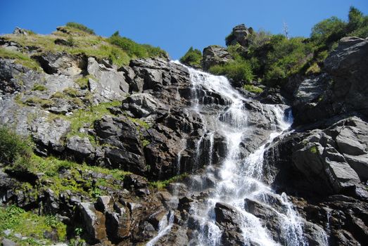 Waterfall near Transfagarasan, a famous road in Romania, crossing the mountains.
