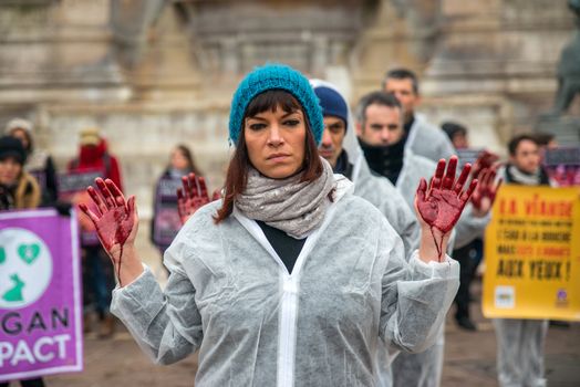 FRANCE, Paris: A member of the Vegan Impact association poses with bloody hands, during a demonstration commemorating International Day without Meat, at Saint-Michel square in Paris, on March 19, 2016.