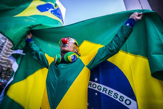 BRAZIL, Sao Paulo : A protester holds a Brazilian flag during a demonstration against Brazilian former president (2003-2011) Luiz Inacio Lula da Silva in Sao Paulo, Brazil on March 19 2016. Brazilian lawmakers relaunched impeachment proceedings against President Dilma Rousseff Thursday and a judge blocked her bid to bring her powerful predecessor into her cabinet, intensifying the political crisis engulfing her. 
