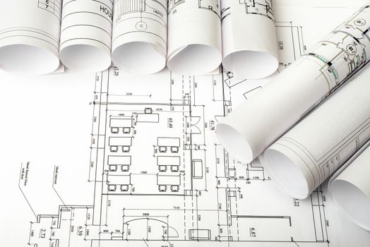 Blueprints and rolls of blueprints, top view. Building concept