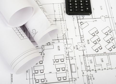 Architecture plan and rolls of blueprints with calculator. Building concept