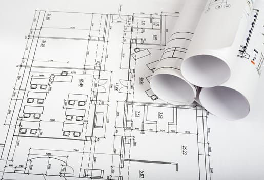 Blueprints and rolls of blueprints, side view. Building concept