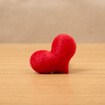 red heart on wood table background