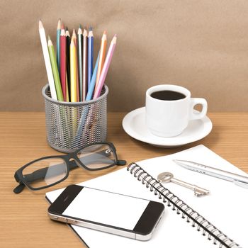 office desk : coffee and phone with key,eyeglasses,notepad,pencil box