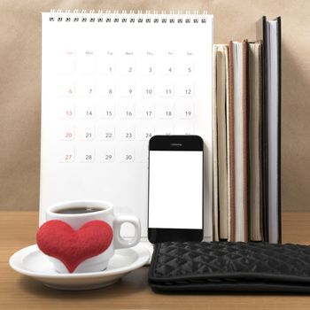 office desk : coffee with phone,wallet,calendar,heart,stack of book on wood background