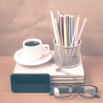 office desk : coffee and phone with key,eyeglasses,stack of book,pencil box vintage style
