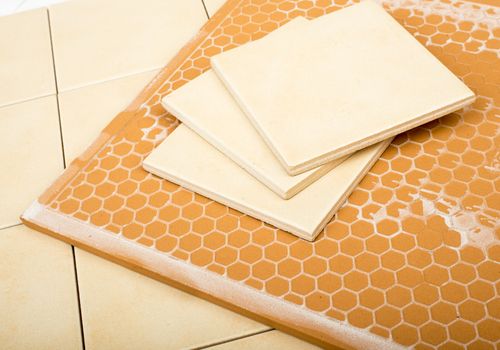 Set of tiles and tile wall isolated on floor, closeup