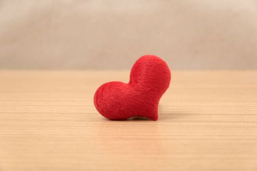 red heart on wood table background