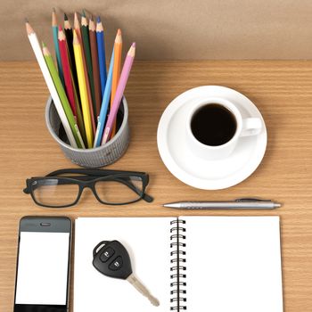 office desk : coffee and phone with key,eyeglasses,notepad,pencil box