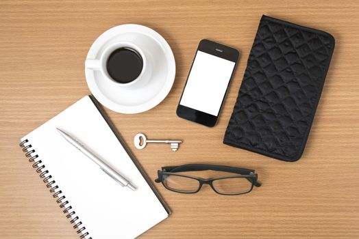 coffee and phone with notepad,key,eyeglasses and wallet on wood table background