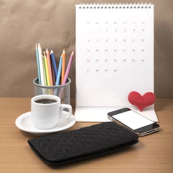 office desk : coffee with phone,wallet,calendar,heart,color pencil box on wood background