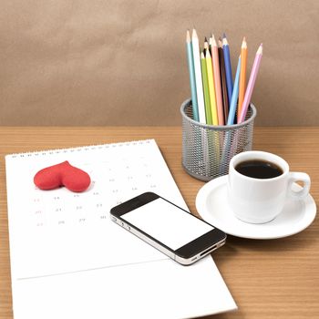 office desk : coffee with phone,calendar,heart on wood background