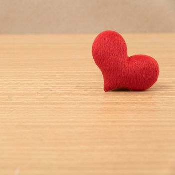red heart on wood table background