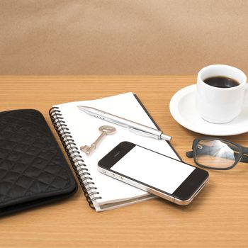 coffee and phone with notepad,key,eyeglasses and wallet on wood table background