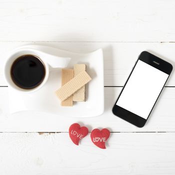 coffee cup with wafer,phone,heart on white wood background