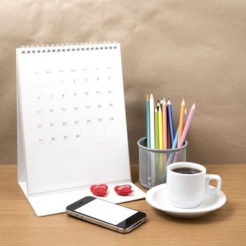 office desk : coffee with phone,calendar,heart,color pencil on wood background
