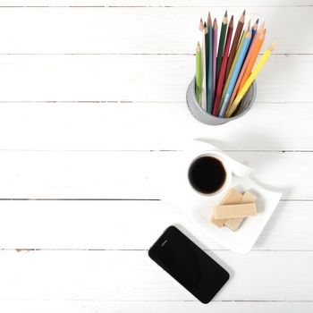 coffee cup with wafer,phone,pencil box on white wood background