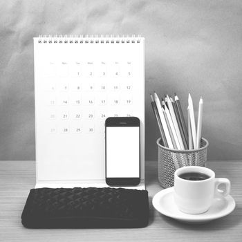 office desk : coffee with phone,calendar,wallet,color pencil on wood background black and white color