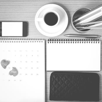 office desk : coffee with phone,wallet,calendar,heart,color pencil box,notepad on wood background black and white color