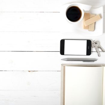 coffee cup with wafer,phone,key,notebook on white wood background