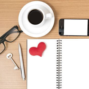 office desk : coffee and phone with key,eyeglasses,notepad,heart on wood background