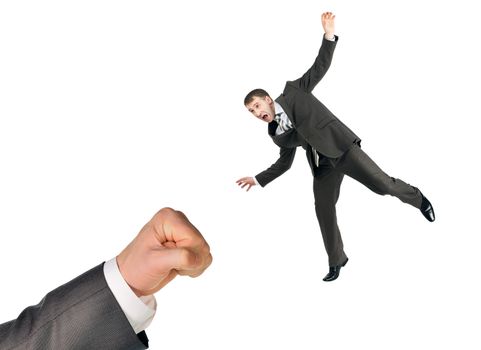Businessman flying from fist hitting isolated on white background