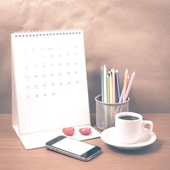 office desk : coffee with phone,calendar,heart,color pencil on wood background vintage style