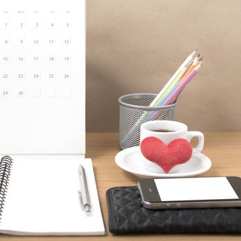 office desk : coffee with phone,wallet,calendar,heart,color pencil box,notepad,heart on wood background