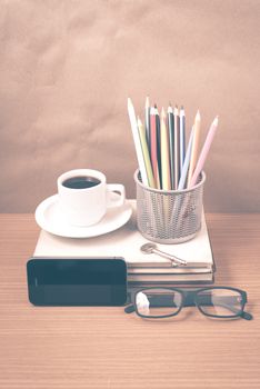 office desk : coffee and phone with key,eyeglasses,stack of book,pencil box vintage style