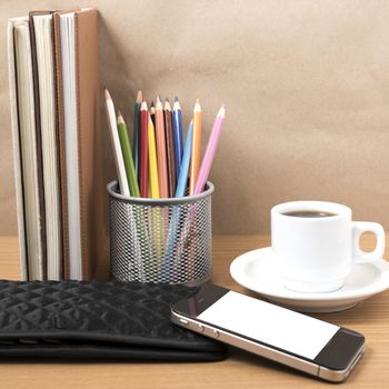 office desk : coffee with phone,stack of book,wallet,color box on wood background