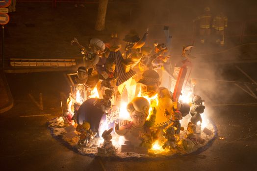 SPAIN, Valencia : Ninots burn on the last night of the Fallas Festival in Valencia on March 19, 2016.Fallas are gigantic structures made of cardboard portraying current events and personalities in which individual figures or Ninots are placed. The Fallas are burnt in the streets of Valencia as a tribute to St Joseph, patron saint of the carpenters' guild. 