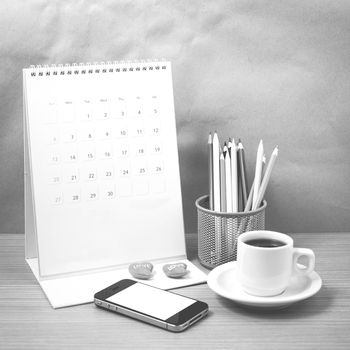 office desk : coffee with phone,calendar,heart,color pencil on wood background black and white color