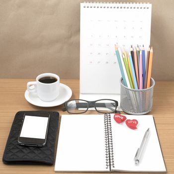 office desk : coffee with phone,wallet,calendar,color pencil box,notepad,heart on wood background