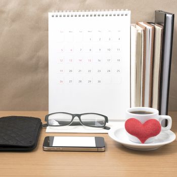 desktop : coffee with phone,stack of book,wallet,heart,eyeglasses,calendar on wood background