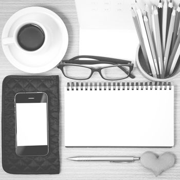 office desk : coffee with phone,wallet,calendar,color pencil box,notepad,heart on wood background black and white color