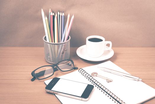 office desk : coffee and phone with key,eyeglasses,notepad,pencil box vintage style