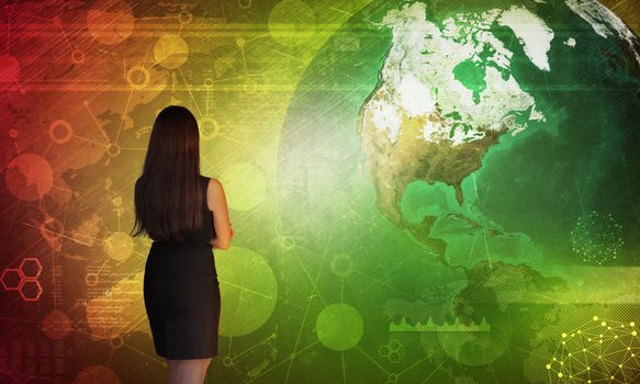 Business woman in front of holographic screen with earth globe. Elements of this image furnished by NASA
