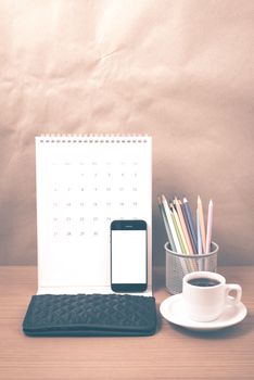 office desk : coffee with phone,calendar,wallet,color pencil on wood background vintage style