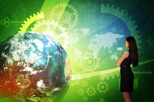 Business woman in front of holographic screen with earth globe and cog wheels. Elements of this image furnished by NASA