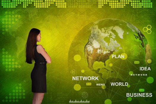 Business woman in front of holographic screen with earth globe and business words. Elements of this image furnished by NASA
