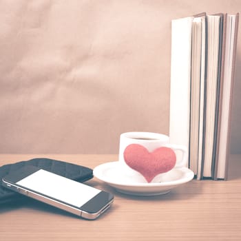 working table : coffee with phone,stack of book,wallet and heart on wood background vintage style