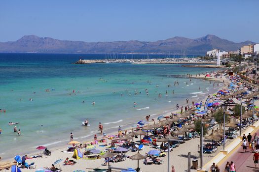 Mallorca, Spain - June 29, 2015: The tourists enjoiying their vacation on the beach. Up to 60 mln tourists is expected to visit Spain in year 2015.