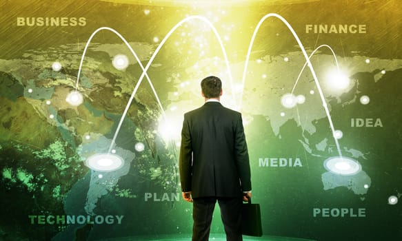 Businessman in front of holographic screen with earth globe and business words. Elements of this image furnished by NASA